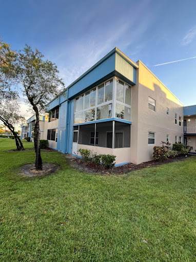 Condominium building with a glass-enclosed balcony and new windows