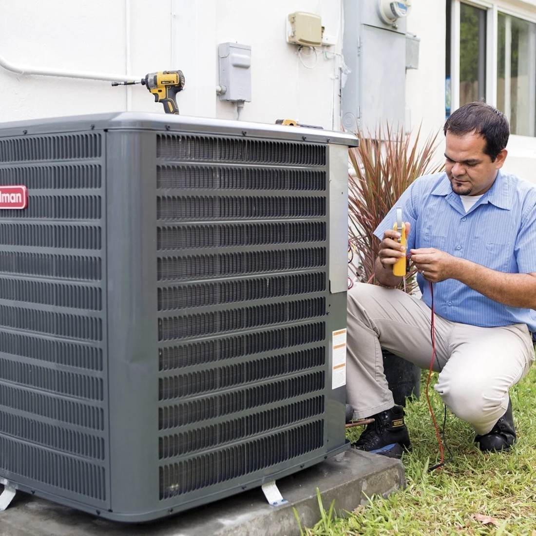 1 OAK technician testing the wiring on a newly installed AC condenser