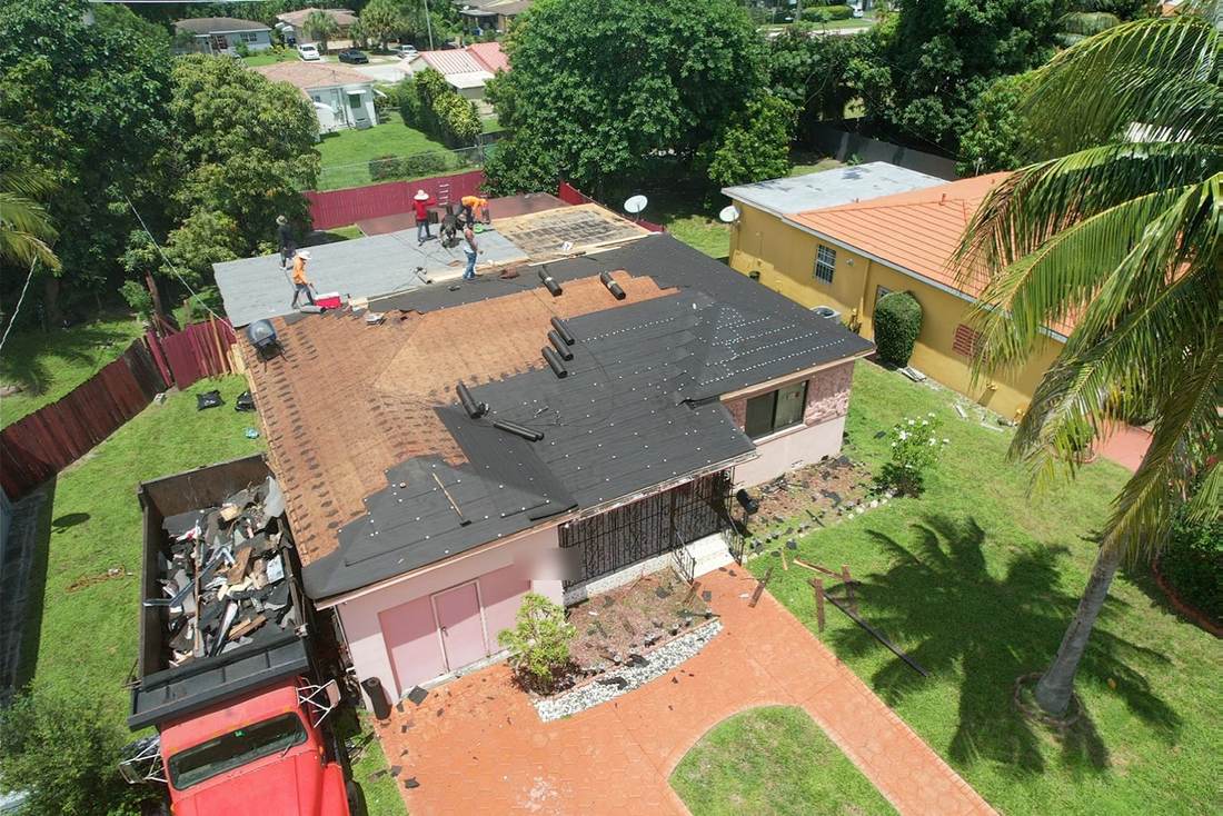 Roof replacement in progress with old shingles removed and new underlayment going down
