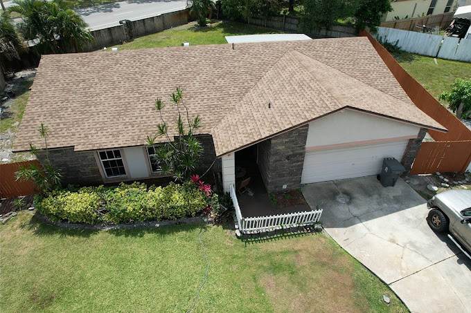 Aerial view of a home with a new architectural shingle roof by 1 OAK Home Improvement