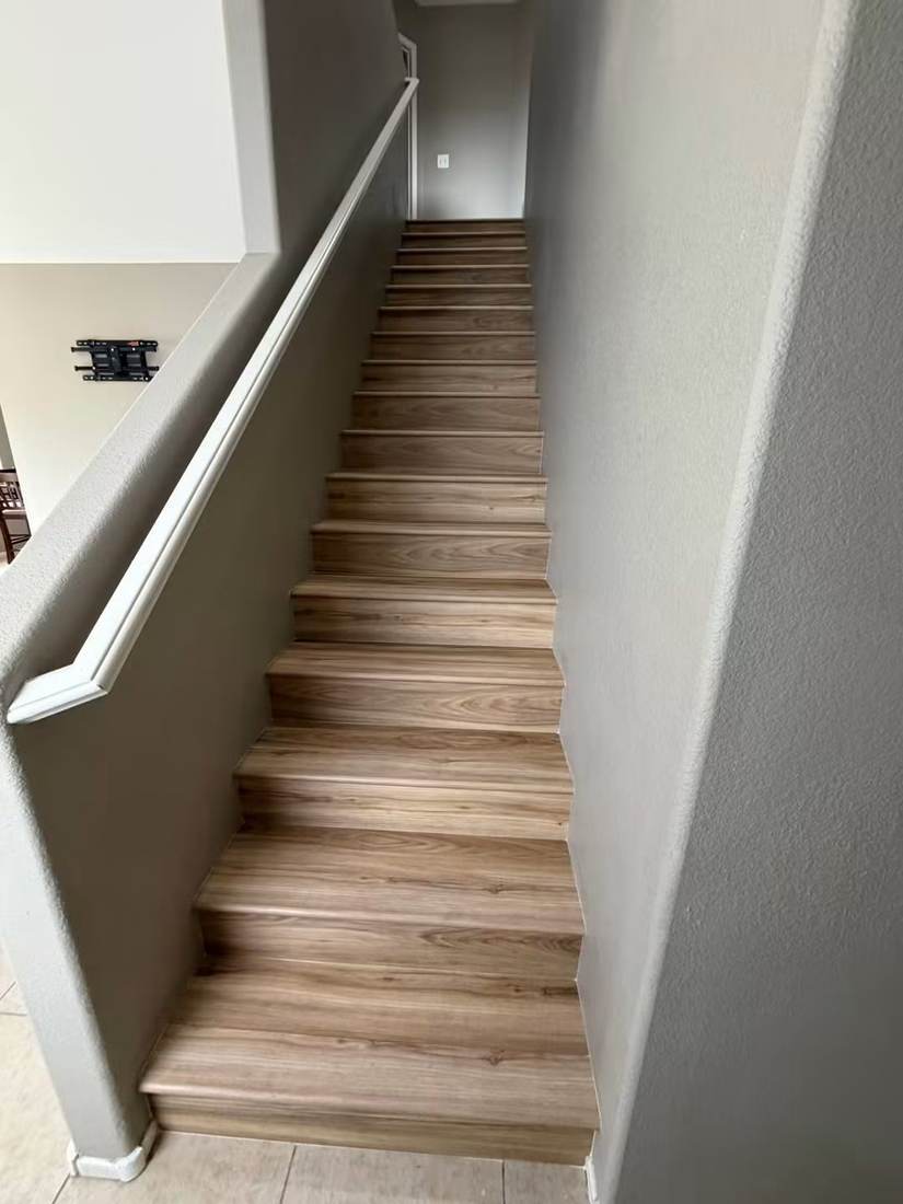 Staircase finished with wood-look stair treads and risers